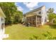 Expansive backyard featuring a screened porch, patio area, lush lawn, and mature landscaping at 2632 Planters Pointe Blvd, Mount Pleasant, SC 29466