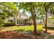 Spacious backyard with a patio, screened porch, and lush green lawn, ideal for outdoor entertaining and relaxation at 2632 Planters Pointe Blvd, Mount Pleasant, SC 29466
