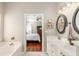 Bright bathroom with double sinks, large tub, and doorway view to a bedroom offering a glimpse of comfort at 2632 Planters Pointe Blvd, Mount Pleasant, SC 29466