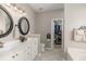 Bathroom featuring double sinks, an accessible closet, and tile flooring for a clean and modern design at 2632 Planters Pointe Blvd, Mount Pleasant, SC 29466
