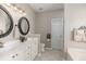 Bright bathroom with double sinks, decorative mirrors, and tiled floors providing a modern aesthetic at 2632 Planters Pointe Blvd, Mount Pleasant, SC 29466