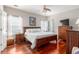 Comfortable bedroom with hardwood floors, a ceiling fan, and ample natural light from the bright windows at 2632 Planters Pointe Blvd, Mount Pleasant, SC 29466
