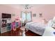 Bright and cozy bedroom with a pink accent wall, toys, desk and chair and a comfortable bed at 2632 Planters Pointe Blvd, Mount Pleasant, SC 29466