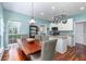 Inviting dining area showcasing a wood table, wicker chairs, and an adjacent kitchen with modern appliances at 2632 Planters Pointe Blvd, Mount Pleasant, SC 29466