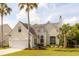 Charming two-story home featuring a well-manicured lawn and beautiful landscaping with mature palm trees at 2632 Planters Pointe Blvd, Mount Pleasant, SC 29466