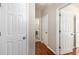 Hallway with multiple doors, including one leading to a laundry room, showcasing a functional home layout at 2632 Planters Pointe Blvd, Mount Pleasant, SC 29466