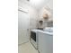 Well-equipped laundry room with modern washer and dryer units, wire shelving and ample space at 2632 Planters Pointe Blvd, Mount Pleasant, SC 29466