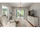 Cozy living room with a stylish chandelier and a tranquil view from the window at 2632 Planters Pointe Blvd, Mount Pleasant, SC 29466