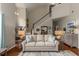 Spacious living room featuring a staircase, stylish sofa, hardwood floors, and tasteful decor at 2632 Planters Pointe Blvd, Mount Pleasant, SC 29466