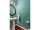 Stylish powder room with a pedestal sink, decorative mirror, and unique green textured walls at 2632 Planters Pointe Blvd, Mount Pleasant, SC 29466