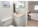 Well-lit bathroom vanity with adjacent toilet, shower, and decorative art at 2901 Dove Haven Ct # C, Charleston, SC 29414