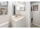 Well-lit bathroom features a vanity sink with marble countertop and a stacked washer and dryer at 2901 Dove Haven Ct # C, Charleston, SC 29414
