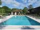 Community pool with inviting blue water, surrounded by lounge chairs for residents to relax and enjoy sunny days at 2901 Dove Haven Ct # C, Charleston, SC 29414