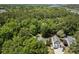 An aerial view of a home surrounded by lush trees and landscaping near a river at 3021 Rushland Mews, Johns Island, SC 29455