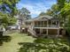 Backyard featuring a deck with outdoor seating, lush lawn, and trees at 3021 Rushland Mews, Johns Island, SC 29455