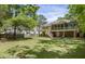 Backyard featuring a spacious lawn with privacy fence and deck with outdoor seating at 3021 Rushland Mews, Johns Island, SC 29455