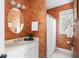 Bathroom featuring orange palm wallpaper, white vanity, and an oval mirror at 3021 Rushland Mews, Johns Island, SC 29455
