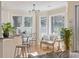 Bright breakfast nook with hardwood floors, modern lighting, and large windows offering natural light at 3021 Rushland Mews, Johns Island, SC 29455