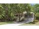 Inviting home with a charming porch, lush greenery, and a convenient two-car attached garage at 3021 Rushland Mews, Johns Island, SC 29455