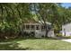 Charming two-story home with a spacious front yard, covered porch and attached two-car garage at 3021 Rushland Mews, Johns Island, SC 29455