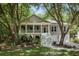 Charming two-story home featuring a welcoming front porch, classic columns, and a beautifully landscaped yard at 3021 Rushland Mews, Johns Island, SC 29455
