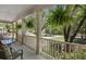 Inviting front porch with comfortable seating and hanging plants, perfect for enjoying the serene neighborhood view at 3021 Rushland Mews, Johns Island, SC 29455