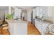 Open kitchen layout with granite countertops, stainless steel appliances, and hardwood flooring at 3021 Rushland Mews, Johns Island, SC 29455