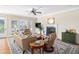 Cozy living room featuring a fireplace, plush seating, a ceiling fan, and access to outdoor spaces at 3021 Rushland Mews, Johns Island, SC 29455