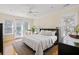 Sun-lit main bedroom featuring hardwood floors and access to a private balcony at 3021 Rushland Mews, Johns Island, SC 29455