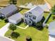 Aerial view of a well-maintained home with a lush green lawn and pond in the backyard at 303 Seneca River Dr, Summerville, SC 29485