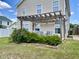 Backyard with a pergola over patio seating and landscaped flower bed at 303 Seneca River Dr, Summerville, SC 29485