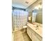 Bathroom featuring a vanity, toilet, shower with palm tree curtain and neutral colored tile floors at 303 Seneca River Dr, Summerville, SC 29485