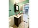 Well-lit bathroom featuring a vanity with storage, and a glimpse of the stairs at 303 Seneca River Dr, Summerville, SC 29485