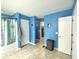 A blue bathroom shows access to a closet, shower/tub and toilet room with neutral colored tile floors at 303 Seneca River Dr, Summerville, SC 29485