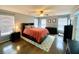 A spacious bedroom features a dark wood bed frame, a ceiling fan and plenty of natural light from multiple windows at 303 Seneca River Dr, Summerville, SC 29485