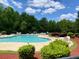 Community pool featuring comfortable lounge chairs and lush landscaping creating a relaxing oasis at 303 Seneca River Dr, Summerville, SC 29485