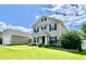 Attractive two-story home with black shutters, covered porch, and landscaped front yard at 303 Seneca River Dr, Summerville, SC 29485