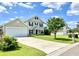 Charming two-story home featuring a manicured lawn and attached two-car garage at 303 Seneca River Dr, Summerville, SC 29485