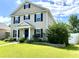 Charming home with a well-manicured lawn, inviting front porch, and beautifully maintained landscaping at 303 Seneca River Dr, Summerville, SC 29485