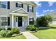 Inviting front porch with a rocking chair and manicured landscaping at 303 Seneca River Dr, Summerville, SC 29485