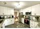 Modern kitchen with stainless steel appliances, white cabinets, and granite countertops at 303 Seneca River Dr, Summerville, SC 29485