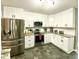 Renovated kitchen with stainless steel appliances, granite countertops, and white cabinets at 303 Seneca River Dr, Summerville, SC 29485