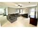 Bright living room with modern gray furniture, ceiling fan, and natural light at 303 Seneca River Dr, Summerville, SC 29485