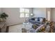Cozy living room featuring a plush sofa, patterned chairs, and a glass coffee table, illuminated by natural light at 303 Willow Run Dr, Summerville, SC 29486