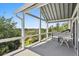 Covered balcony offers scenic views of the surrounding greenery and sky at 314 Commonwealth Rd, Mount Pleasant, SC 29466