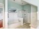 Bathroom showcasing tiled floors, tub, separate glass shower, and serene atmosphere at 314 Commonwealth Rd, Mount Pleasant, SC 29466