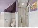 Unique bathroom with a glass enclosed shower, toilet, purple wall, and slanted ceiling at 314 Commonwealth Rd, Mount Pleasant, SC 29466
