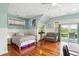 Cozy bedroom with hardwood floors, a built-in desk, natural light, and balcony access at 314 Commonwealth Rd, Mount Pleasant, SC 29466
