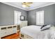 Cozy bedroom featuring hardwood floors, a ceiling fan, and large windows at 314 Commonwealth Rd, Mount Pleasant, SC 29466