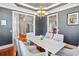 Dining room features a wood floor, chandelier, white trim, and gray walls at 314 Commonwealth Rd, Mount Pleasant, SC 29466